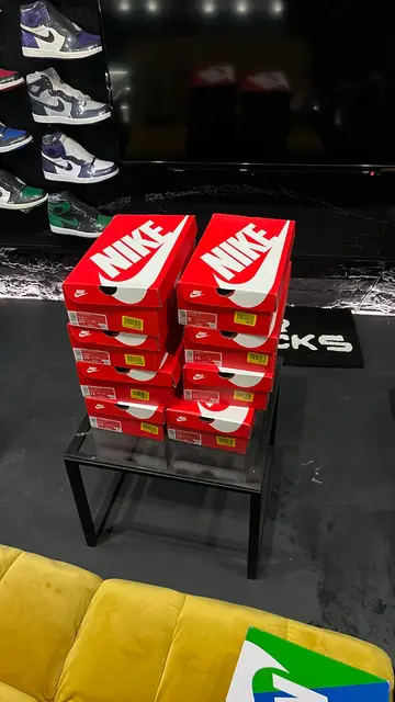 Stacked Nike boxes on a table in a sneaker store