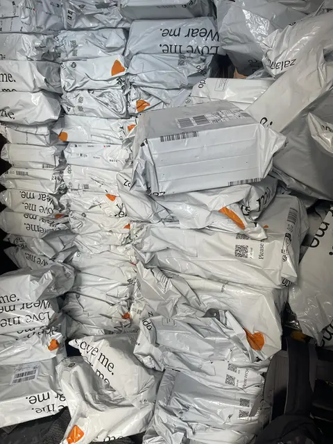 A floor covered in unopened delivery bags