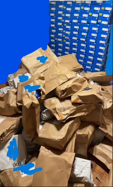 Delivery bags piled in front of a wall of Adidas boxes