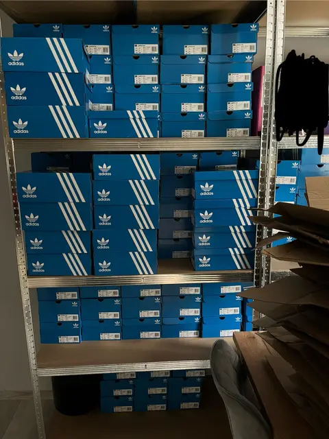 Metal shelving filled with Adidas boxes