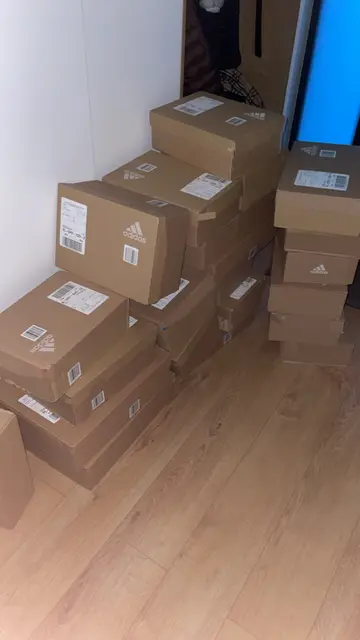 Adidas shipping boxes stacked in a corner