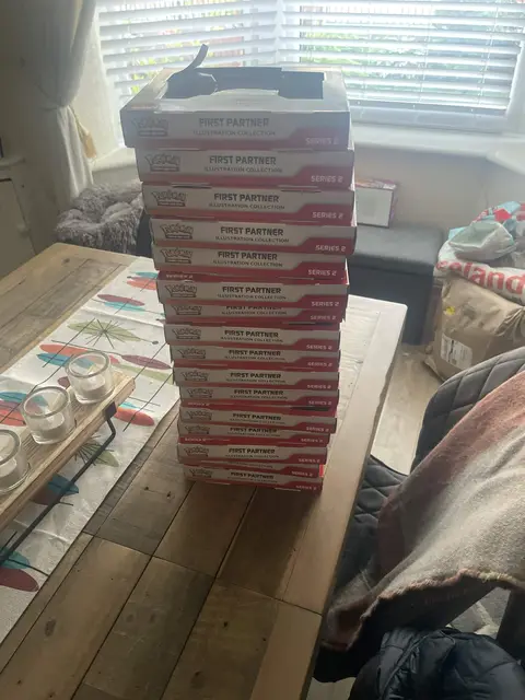 Pokémon First Partner collections stacked on a table