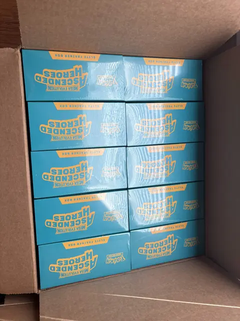 Ten Ascended Heroes Elite Trainer Boxes in a shipping box
